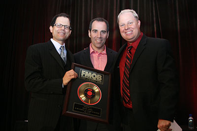 Monte Lipman accepts his prize from Fred Deane.